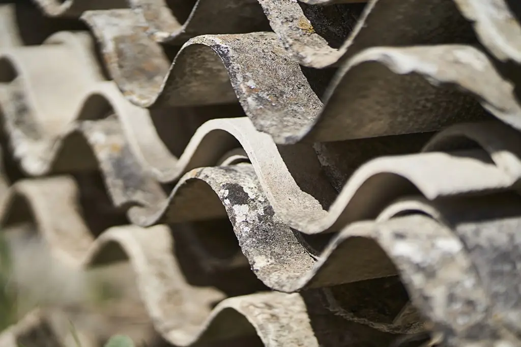 Toxic waste with asbestos sheets piled up on top of one another.